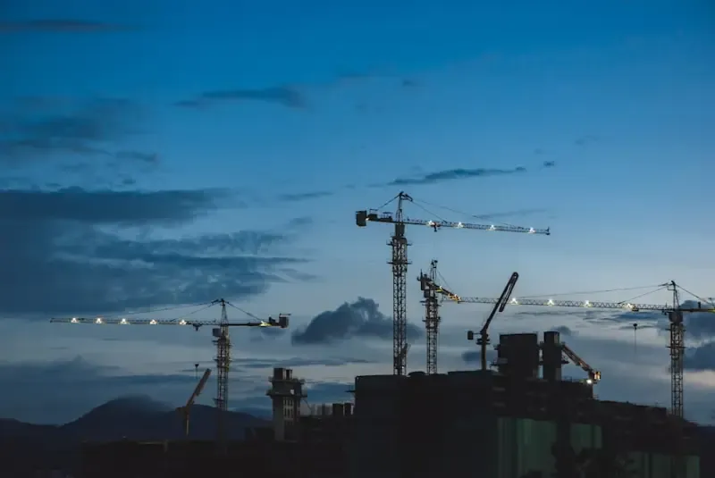 Tower cranes against the skyline of a commercial construction site