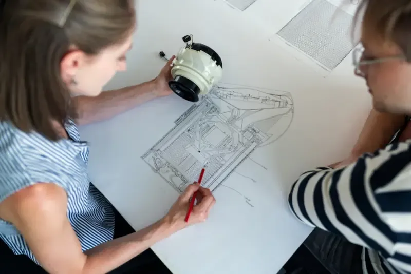 Engineers reviewing a detailed architectural drawing