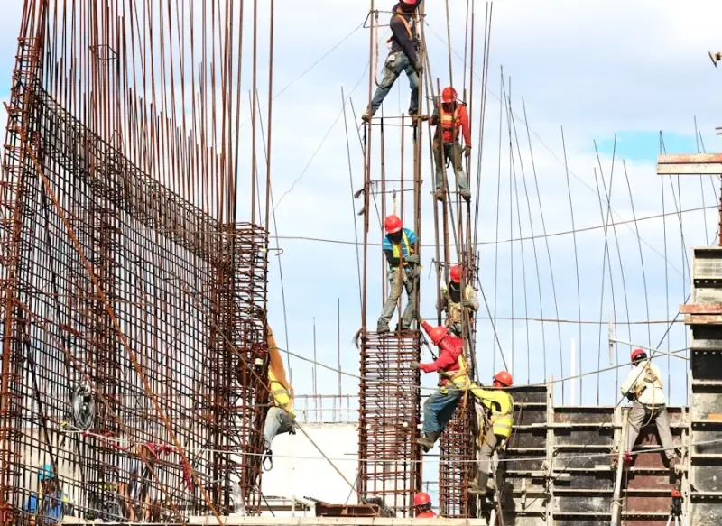 Crew working on structural reinforcement at height on a large building project